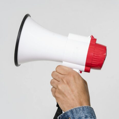 Man In Blue Denim Jacket Holding A Megaphone